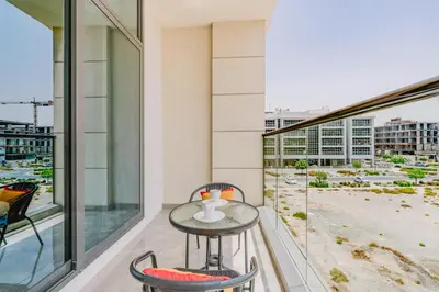 a table on a balcony with a view of a city at RH-Smart Studio Near Expocity & Al Maktoum Airport in Dubai
