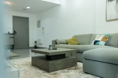 a living room with a couch and a coffee table at Dubai Marina - 1 BHK Elegant & Modern Apartment in Dubai