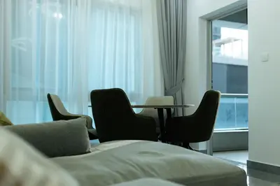 a room with a table and chairs and a bed at Dubai Marina - 1 BHK Elegant & Modern Apartment in Dubai