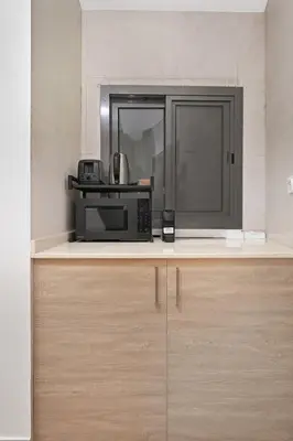 a microwave sitting on top of a counter at Golden Stays - Opulent 2BR View Residence at The Bay in Dubai