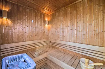 an empty wooden sauna with a blue tub in it at Golden Stays - Opulent 2BR View Residence at The Bay in Dubai