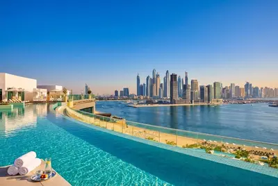 a infinity pool with a view of the city at Seven Palm! Rooftop Infinity Pool with Great View! Private Beach Access! in Dubai
