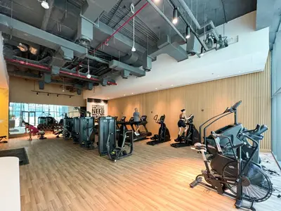 a gym with treadmills and exercise bikes in a room at Seven Palm! Rooftop Infinity Pool with Great View! Private Beach Access! in Dubai