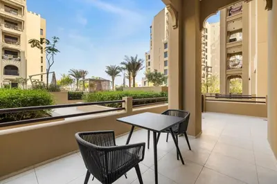 a table and two chairs on a balcony with a view at Modern 1BR in Jadeel 2 MJL in Low Floor in Dubai