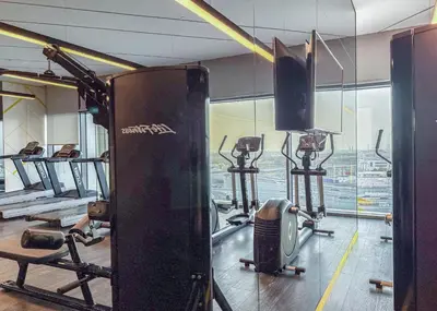 a gym with cardio equipment and a large window at StayShort - Inviting 2BR in Business Bay with Wonderful Views in Dubai