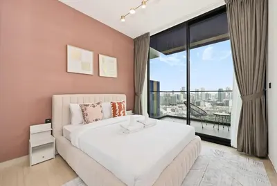 a bedroom with a large bed and a large window at Golden Stays - Chic 1BR Oasis Serene & Private in Dubai