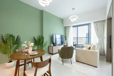a living room with a table and a couch at KeyRock Living - Luxury Apartment with Pool & Gym in Dubai