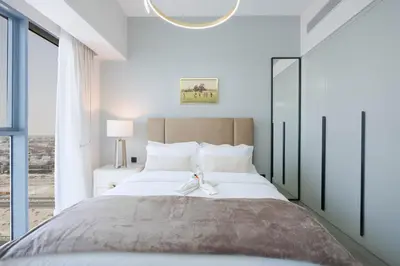 a bedroom with a large bed with a large window at KeyRock Living - Luxury Apartment with Pool & Gym in Dubai