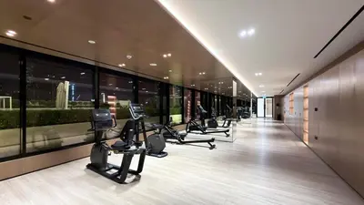 a gym with treadmills and ellipticals in a building at FiveX Binghatti 2BR with Private Pool in Dubai