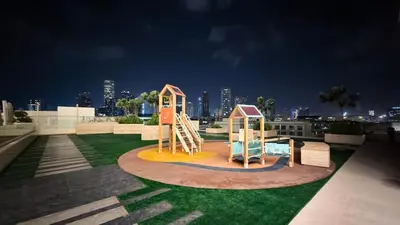 a playground on a roof with a city in the background at FiveX Binghatti 2BR with Private Pool in Dubai