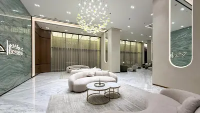 a lobby with a couch and chairs and a chandelier at FiveX Binghatti 2BR with Private Pool in Dubai