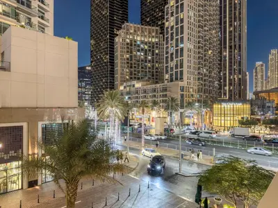 a city at night with cars and buildings at FIRST CLASS 2BR Stylish Downtown Living in Dubai