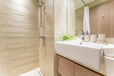 a bathroom with a white sink and a shower at Contemporary Studio Apartment with Balcony & Community Views - Azizi Riviera 48, Al Merkadh by Deluxe Holiday Homes in Dubai