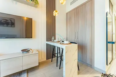 a room with a desk and a table with a mirror at Contemporary Studio Apartment with Balcony & Community Views - Azizi Riviera 48, Al Merkadh by Deluxe Holiday Homes in Dubai