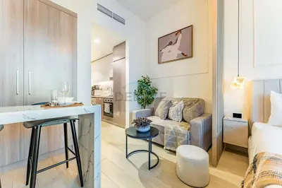 a living room with a couch and a table at Contemporary Studio Apartment with Balcony & Community Views - Azizi Riviera 48, Al Merkadh by Deluxe Holiday Homes in Dubai