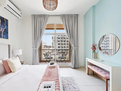 a bedroom with a bed and a window with a view at Prestige Urban Escape 2BDR In La Fontana in Dubai