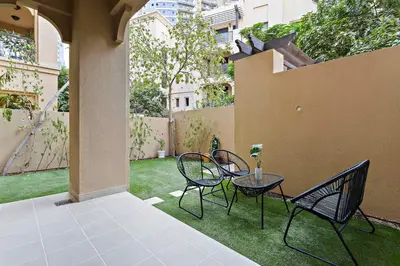 a patio with two chairs and a table at Silkhaus Private Garden in Old Town Zanzebeel Bldg in Dubai