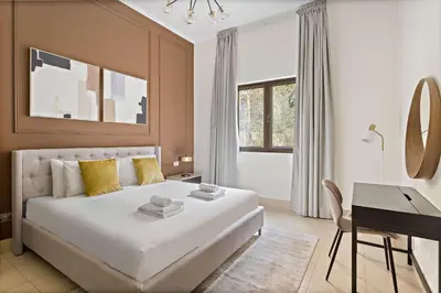 a bedroom with a large white bed and a desk at Silkhaus Private Garden in Old Town Zanzebeel Bldg in Dubai