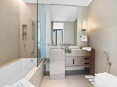 a bathroom with a tub and a sink and a shower at Timeless Elegance 1BR Address Beach JBR in Dubai