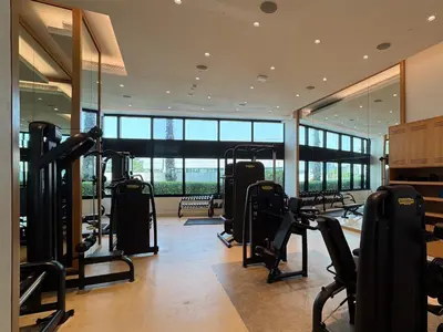 a gym with treadmills and ellipticals in a building at Timeless Elegance 1BR Address Beach JBR in Dubai