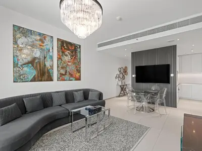 a living room with a couch and a table at Timeless Elegance 1BR Address Beach JBR in Dubai