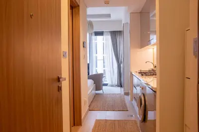 a bathroom with a tub and a sink and a toilet at Snug Modern Downtown Dubai Studio in Dubai