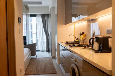 a kitchen with a sink and a counter top at Snug Modern Downtown Dubai Studio in Dubai