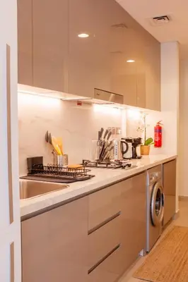 a kitchen with a sink and a stove at Snug Modern Downtown Dubai Studio in Dubai