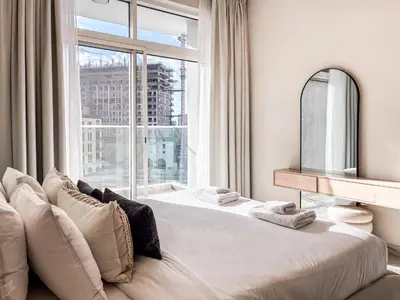 a bedroom with a bed with a large window at Jewelz by Danube, Arjan, Al Barsha - Onelink in Dubai