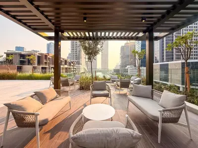 a patio with couches and chairs and a table at GuestReady - 1BR Luxury | Prime City Area in Dubai