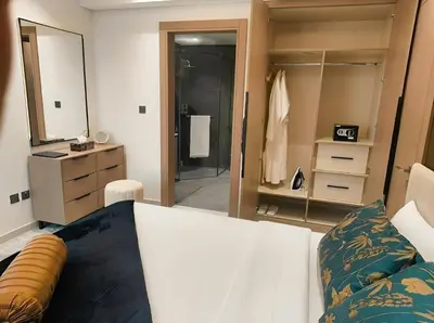 a bedroom with a couch and a large mirror at Jumeirah Village Triangle in Dubai