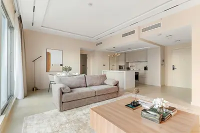 a living room with a couch and a table at FIRST CLASS 1BR Elegance Near Burj Khalifa in Dubai