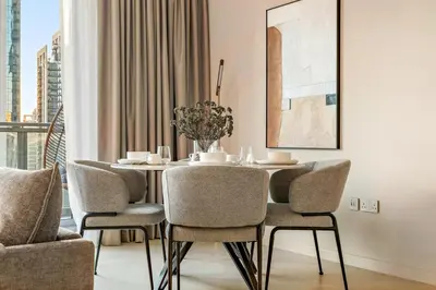 a dining room with a table and chairs at FIRST CLASS 1BR Elegance Near Burj Khalifa in Dubai