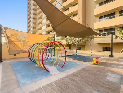 a playground in front of a building with a slide at FIRST CLASS Studio Cozy Luxe Retreat in Dubai