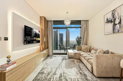 a living room with a couch and a large window at Curated High Floor 1BR-Sofa Bed Water View Peninsula 1 in Dubai
