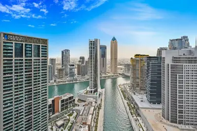 a view of a city with a river and buildings at Curated High Floor 1BR-Sofa Bed Water View Peninsula 1 in Dubai