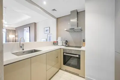 a kitchen with a sink and a microwave at Amazing 1BR DAMAC Towers by Paramount in Dubai