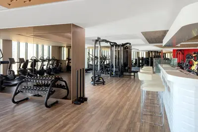 a gym with several treadmills and tread machines at Amazing 1BR DAMAC Towers by Paramount in Dubai