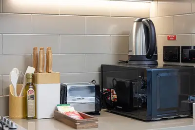 a kitchen counter with a microwave and a coffee maker at Burj Khalifa & Downtown Skyline View Apartment in Dubai