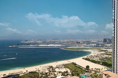 an aerial view of a beach and the ocean at Beachfront Spacious Apartment with Sea & Palm Views in Dubai