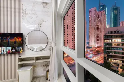 a room with a window with a view of a city at Luxury Duplex Penthouse with Stunning Marina Views in Dubai