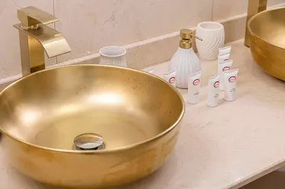 a gold sink on a counter in a bathroom at Luxury Duplex Penthouse with Stunning Marina Views in Dubai