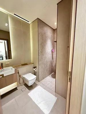 a bathroom with a shower and a toilet and a sink at Modern1BR Binghatti Phantom Private pool JVC in Dubai