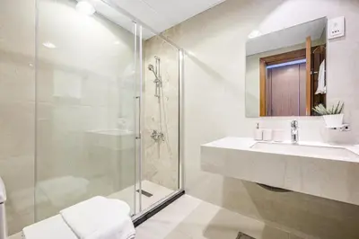 a bathroom with a shower and a sink at Amazing View Studio Lago Vista IMPZ in Dubai