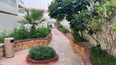 a garden with trees and plants in a building at Spacious and Cozy 1BR Opal Tower Stunning Marina View in Dubai