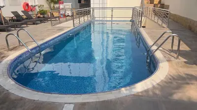 a swimming pool with blue water in a building at Spacious and Cozy 1BR Opal Tower Stunning Marina View in Dubai