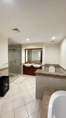 a bathroom with two sinks and a glass shower at Luxury 1-Bedroom, Golden Mile Palm Jumeirah in Dubai