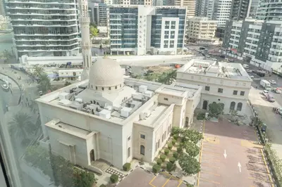 a large white building with a mosque in a city at Luxury Studio at Marina Star - Near JBR - Marina in Dubai