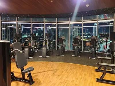a gym with a view of a city at night at Ultra-Luxury Apartment | Burj Khalifa Skyline Pool in Dubai