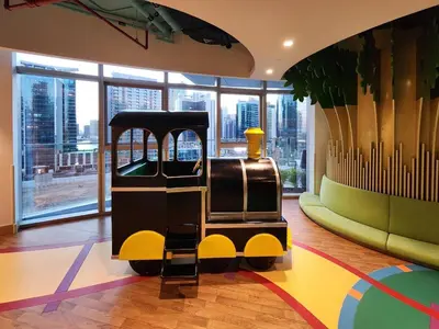 a toy train sitting on the floor in a room at Ultra-Luxury Apartment | Burj Khalifa Skyline Pool in Dubai